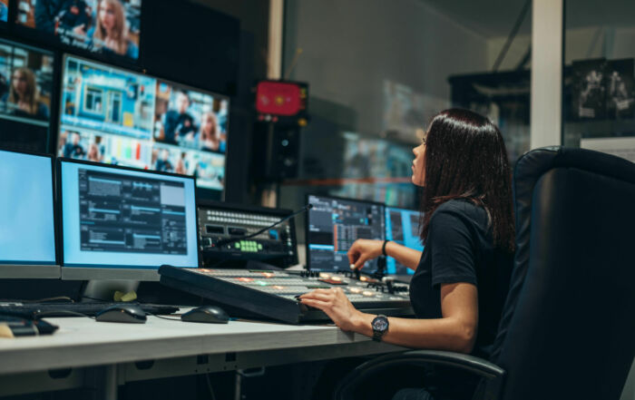Young beautiful woman working in a broadcast control room on a tv station